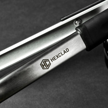A closeup of the HexClad logo on a pair of tongs.