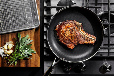 A seared ribeye steak in a HexClad pan, shown from above.