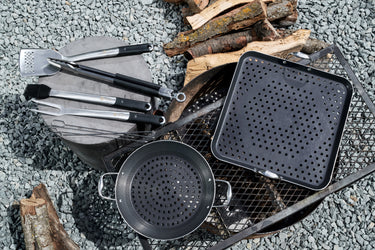 A HexClad grilling set, featuring 2 BBQ grill pans and grilling tools.