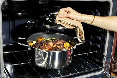 A pot roast cooking in a HexClad dutch oven.