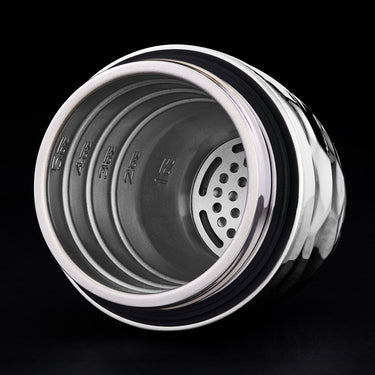 Close-up of a hexclad cocktail shaker top showing the inside with a black background